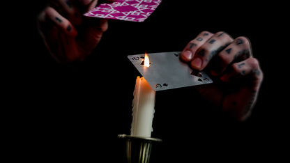 Daniel Madison holding BURN tool over a candle - BURN by Daniel Madison and Eoin O'hare of the Perfect Shuffle template for playing card revelations BURN trick