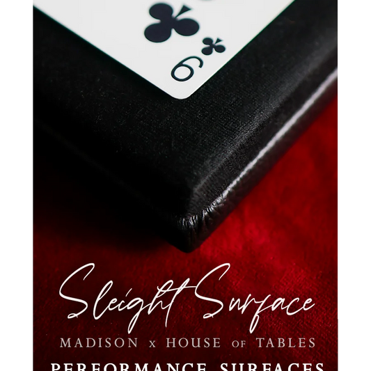 Close-up of a playing card on a red surface with 'Sleight Surface' branding.