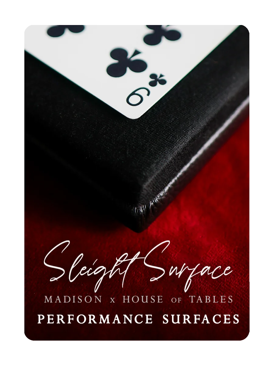 Close-up of a playing card on a red surface with 'Sleight Surface' branding.
