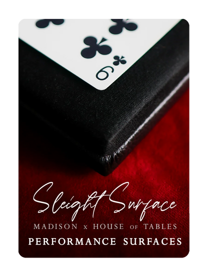 Close-up of a playing card on a red surface with 'Sleight Surface' branding.