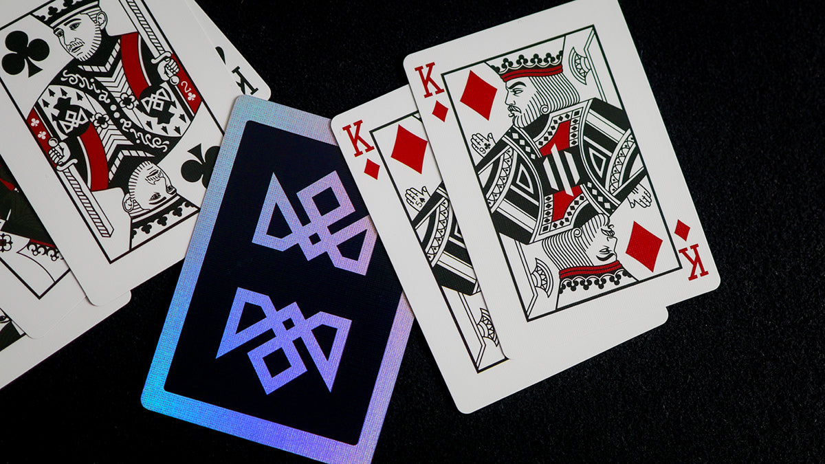Acolyte holographic playing cards by Daniel Madison close-up with two kings of diamonds and logo back, pro magic deck