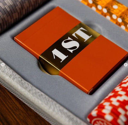 Close-up of a playing card with 'AST' on a textured surface.